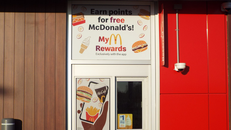 A McDonald's service window displays "MyMcDonald's Rewards" signage, promoting mobile app loyalty points