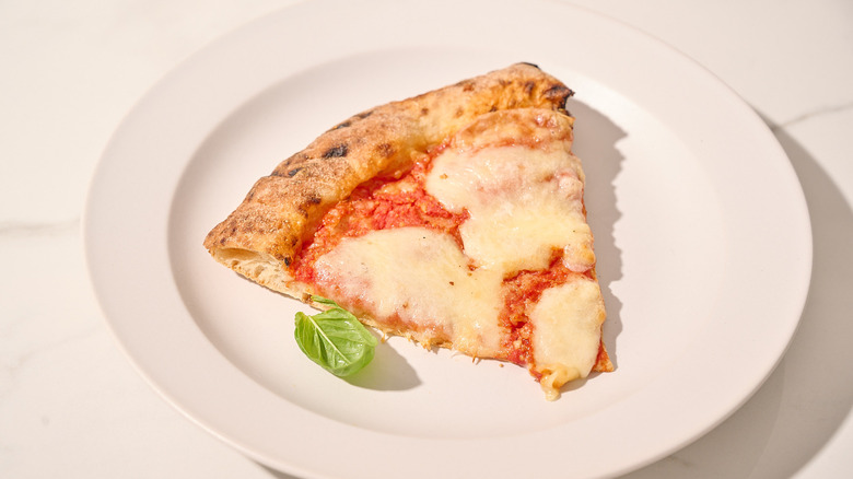 Reheated slice of frozen pizza on a plate