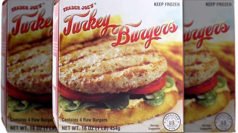 the front of a box of Trader Joe's frozen Turkey Burgers, showing a grilled patty over burger toppings and a bottom bun, with fries in the background