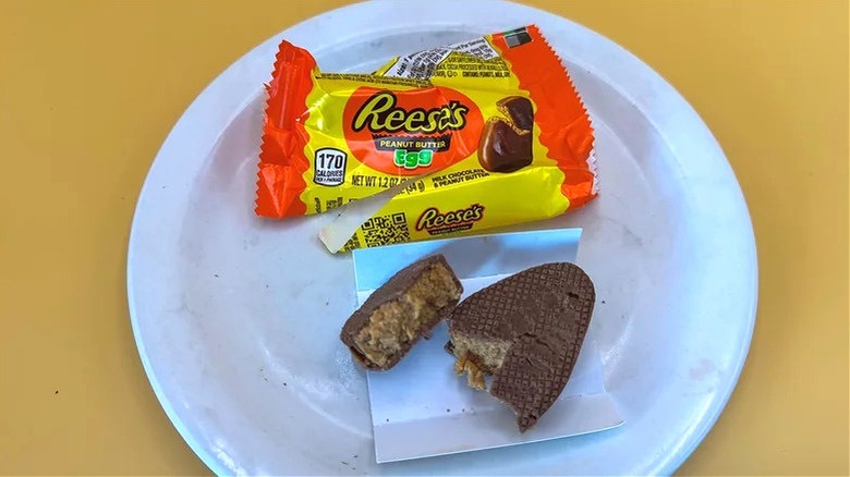 A Reese's Peanut Butter Egg on a white plate.