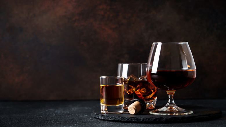 Various shades of whiskey served in different glassware