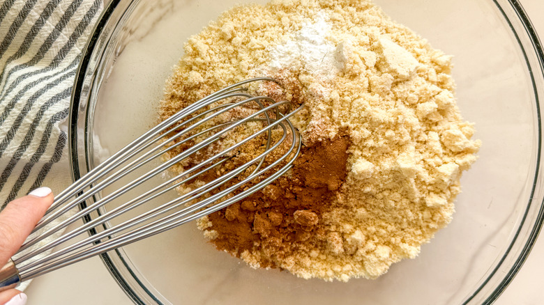 Flour and spices in bowl with whisk