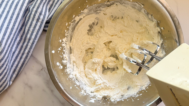 mixing cream with hand beaters