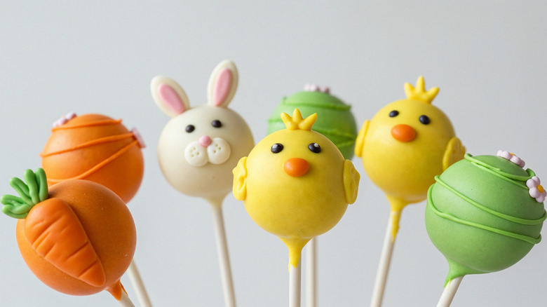 Easter-themed cake pops including carrots, flowers, rabbits, and chicks