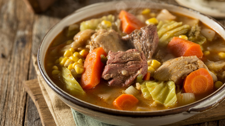 A bowl of booyah stew on a table