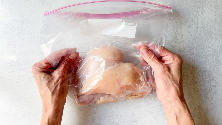 Raw chicken breasts in ziplock bag