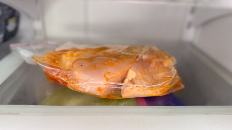 Marinated chicken breasts in ziplock bag in refrigerator