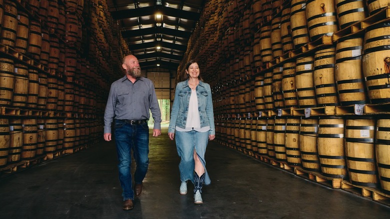 Pete and Vienna Barger in a whiskey rickhouse filled with barrels