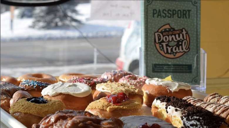 A tray of donuts and the Donut Trail Passport