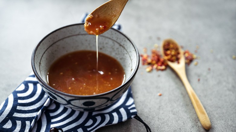 A bowl of dressing appears to be studded with bacon bits.