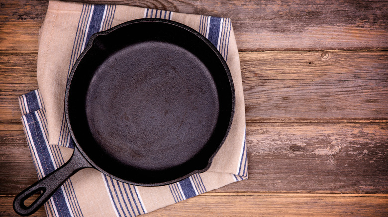 Cast iron skillet on dish towel
