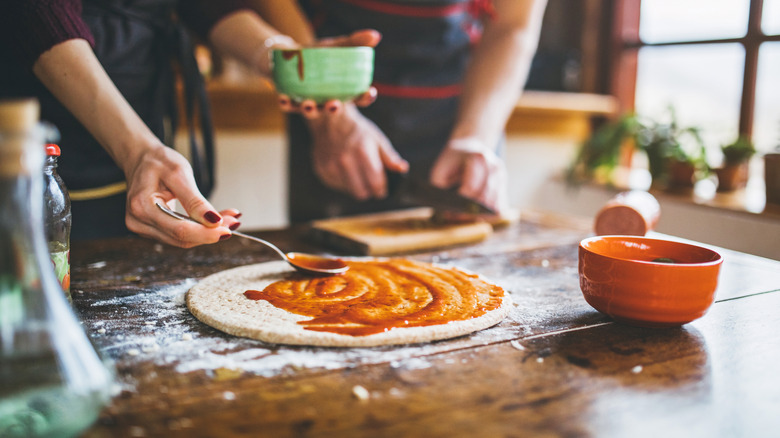 Couple making pizza together
