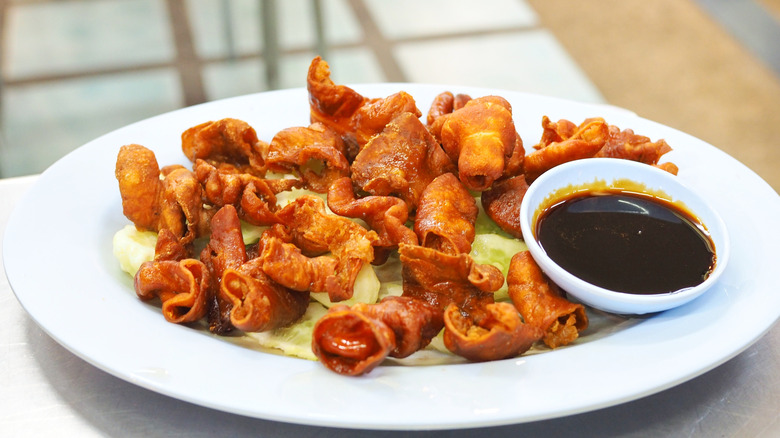 Chitterlings with a sauce on a white plate