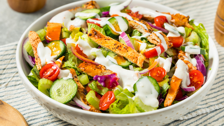 Salad in a white bowl.