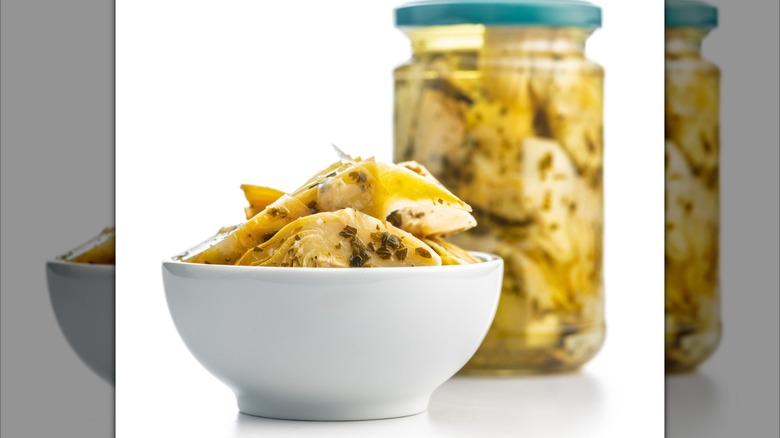 Bowl, jar of marinated artichokes