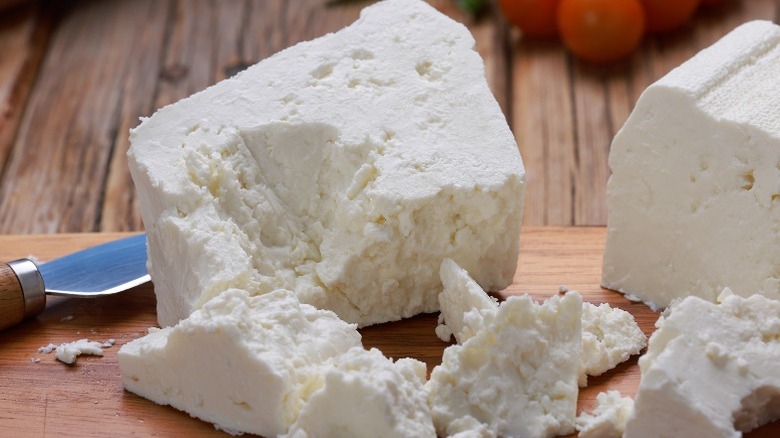 Crumbled feta on cutting board