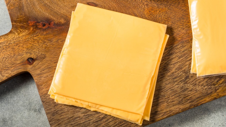Cheese slices on a cutting board