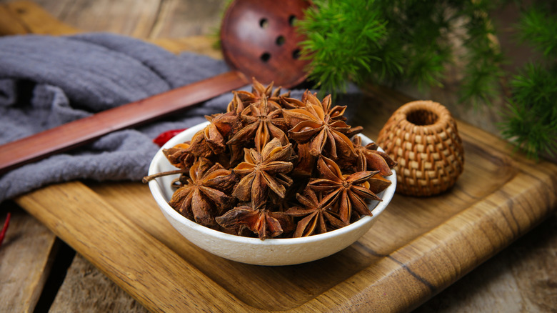 whole dried star anise in a white bowl