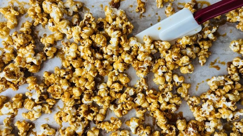 Rubber spatula stirring caramel popcorn