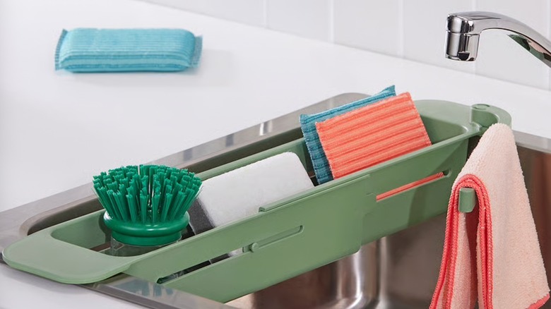 SKOLÄST sink container in stainless steel sink filled with sponges