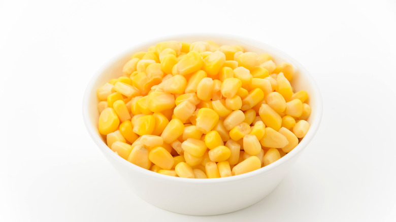 Sweet corn in a white bowl on white background