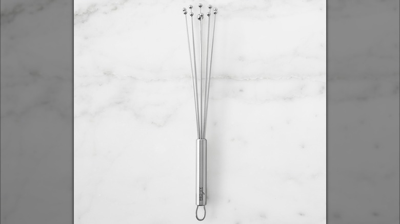 A ball whisk on a marble background
