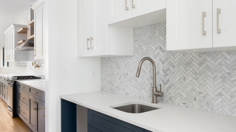 A modern scullery with sink and cabinets
