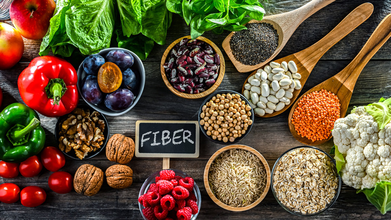 Foods packed with fiber sit around a fiber sign
