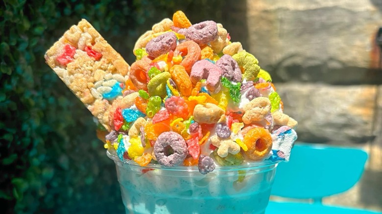 close up of milkshake topped with whipped cream and Fruit Loops