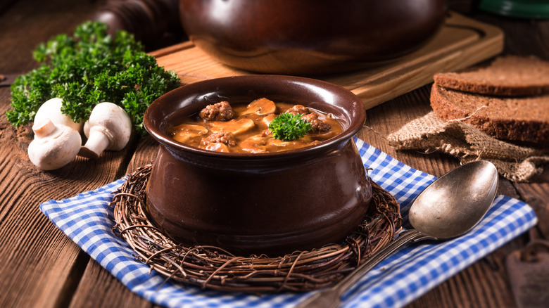 Mock turtle soup in a crock pot on a table.