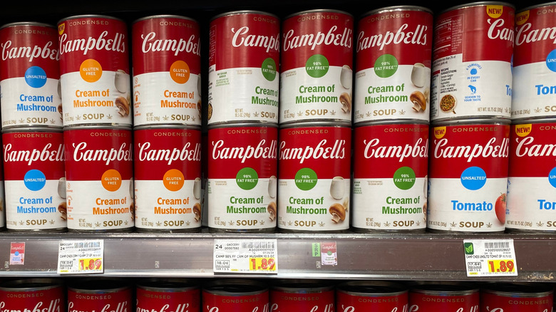 Campbells' soup cans on a store shelf.