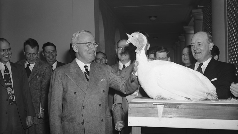 President Harry Truman being presented a turkey