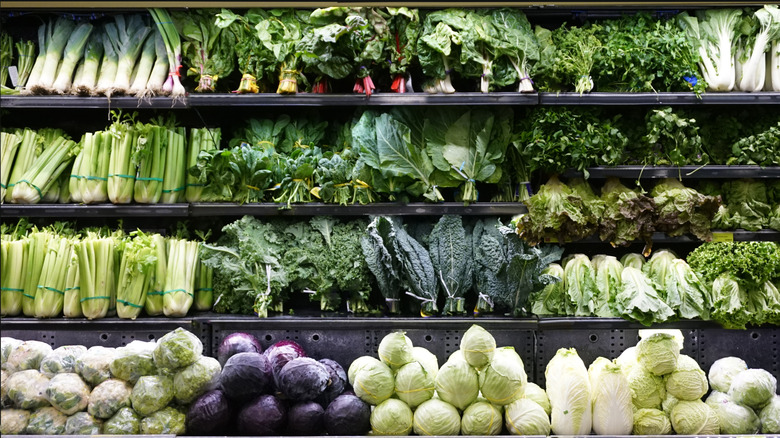 Rows of leafy vegetables on a grocery store shelf