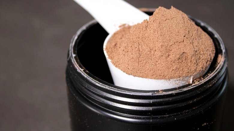 Scooping chocolate powder from container