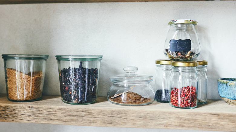 Wood shelf with jars of herbs and spices