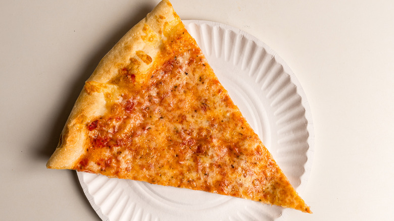 Slice of cheese pizza on paper plate.