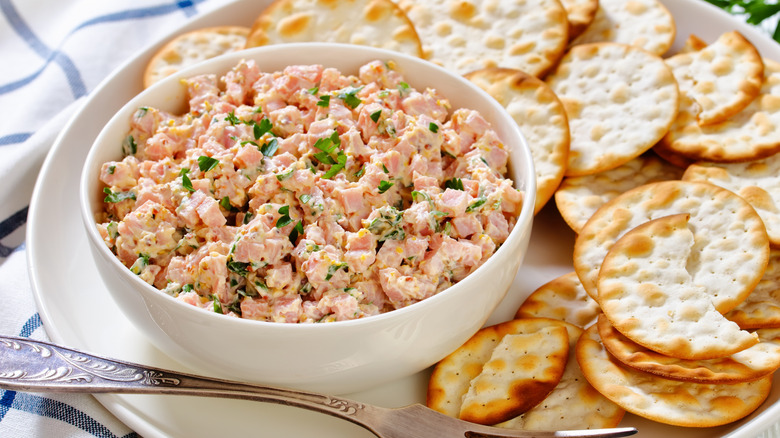 Ham salad spread in a white bowl with crackers