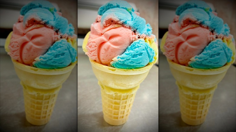 a cone of pink, blue, and yellow Crazy Vanilla ice cream by Hershey's