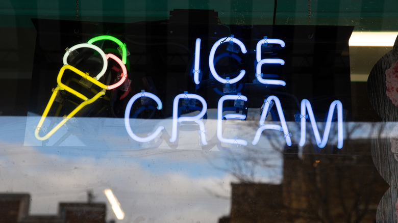 Neon ice cream sign on front window of ice cream shop