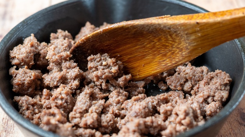 Browning ground beef in a cast-iron.
