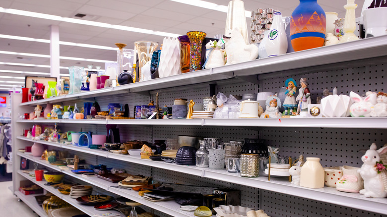 Aisle at a thrift store containing various home goods.