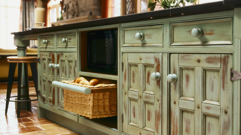 Vintage wooden dresser used for kitchen storage.