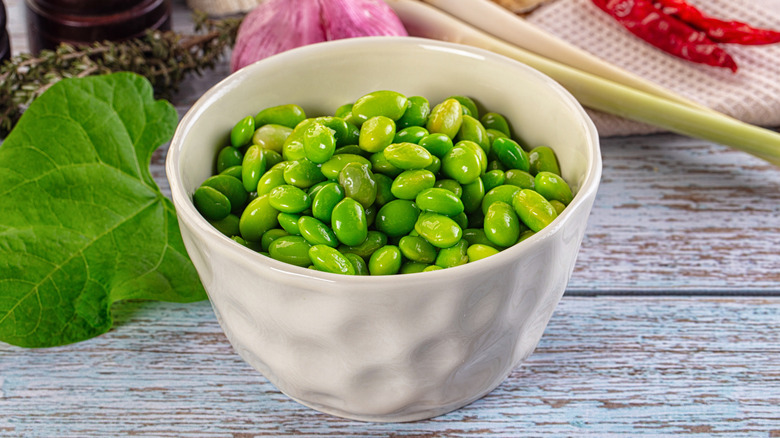 shelled green edamame in a white bowl