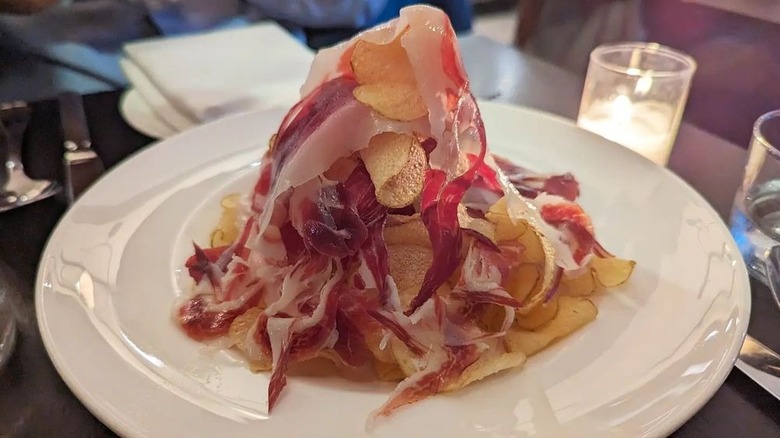 Ernesto's cinco jotas iberico con patatas chips on a white plate