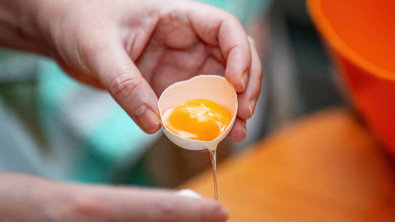 a person separating eggs by hand