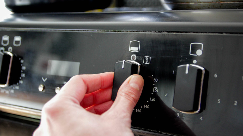 hand adjusting switches on electric oven