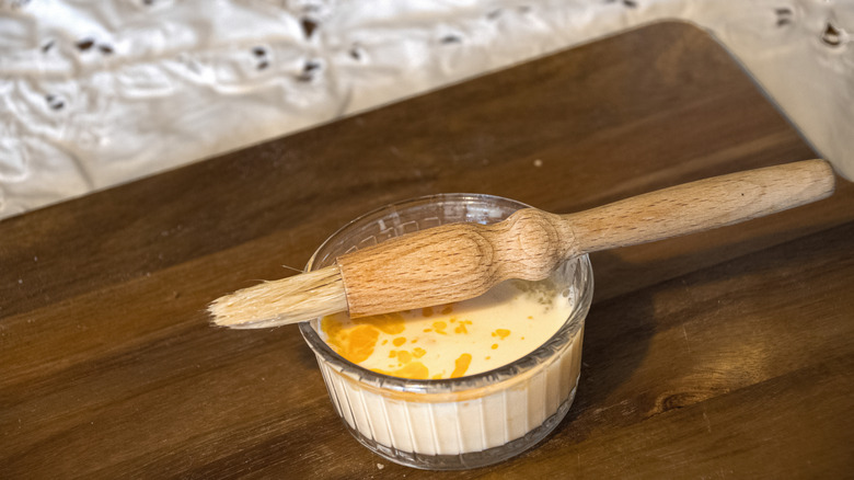 pastry brush and egg wash on wooden table