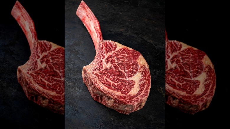 Wagyu tomahawk steak on a black background