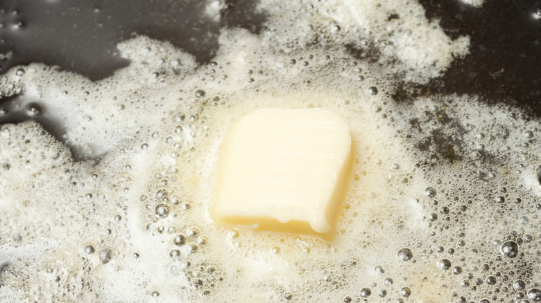 Butter cooking in a cast-iron skillet