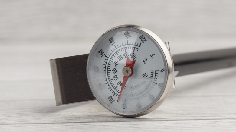 Meat thermometer on a wooden gray surface